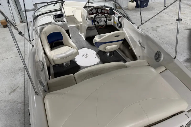 Slide: The Image of 2010 Tahoe Q5i Sport boat interior with white leather seats and modern dashboard. - 5