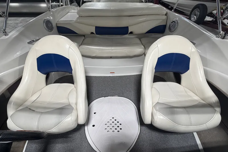 Slide: The Image of 2010 Tahoe Q5i Sport boat interior with white and blue seating. - 11