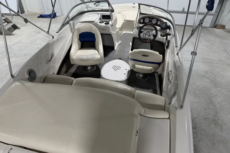 Slide: The Image of 2010 Tahoe Q5i Sport boat interior with white seating and dashboard controls. - 6