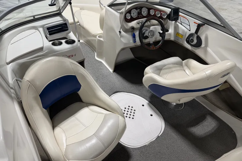 Slide: The Image of Interior of 2010 Tahoe Q5i Sport boat with steering wheel and seating. - 7