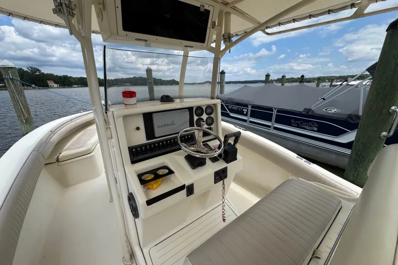 Slide: The Image of 2003 Scout 280 Sportfish boat interior with Garmin navigation system, docked by the water. - 9