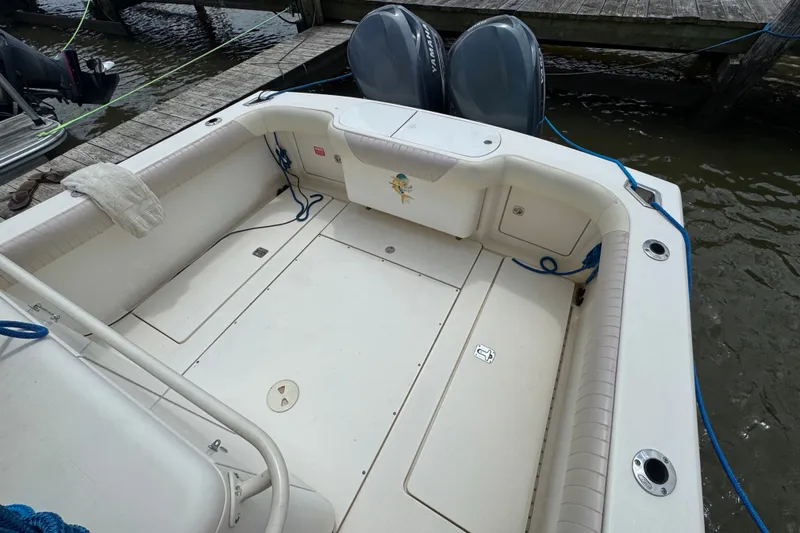 Slide: The Image of 2003 Scout 280 Sportfish boat deck with twin engines at dock. - 3