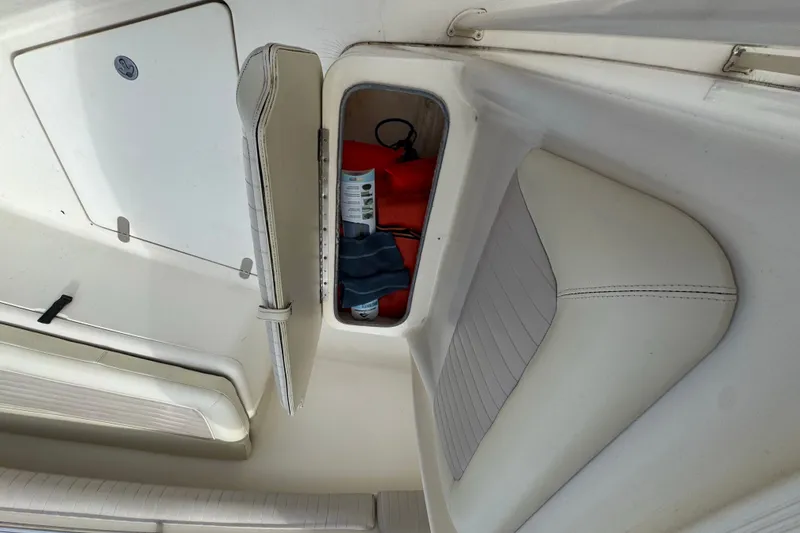 Slide: The Image of Storage compartment on a 2003 Scout 280 Sportfish boat with safety gear inside. - 15