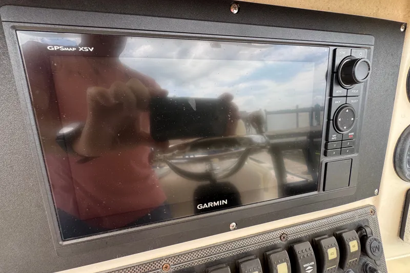 Slide: The Image of Garmin GPSMap XSV on 2003 Scout 280 Sportfish dashboard, reflecting a person taking a photo. - 10