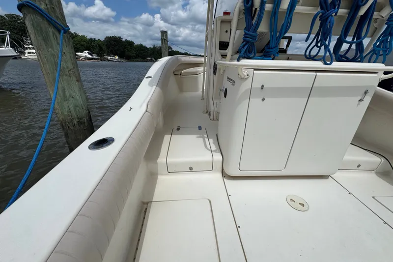 Slide: The Image of 2003 Scout 280 Sportfish boat interior with storage compartments and blue ropes. - 5