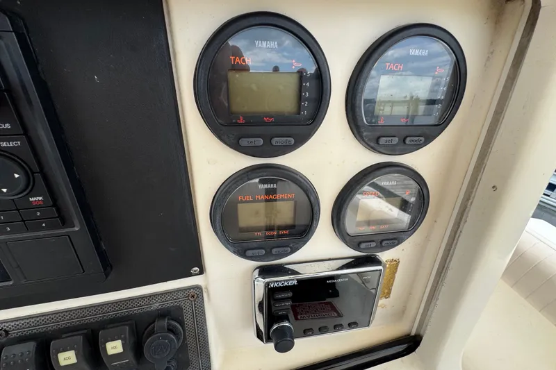 Slide: The Image of Dashboard of a 2003 Scout 280 Sportfish with Yamaha gauges and Kicker media center. - 11
