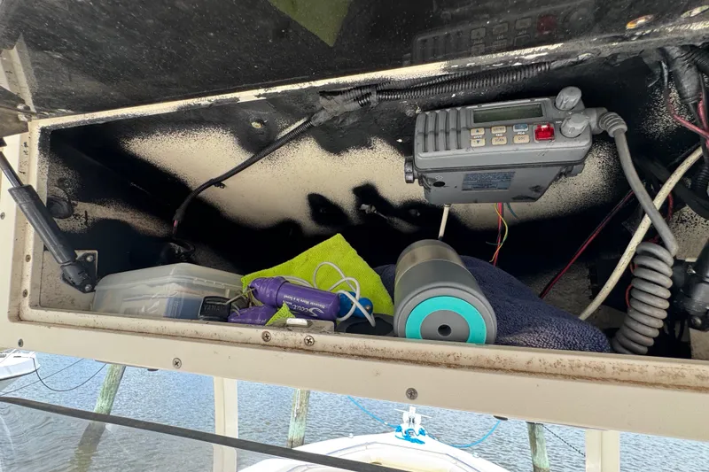 Slide: The Image of Storage compartment of a 2003 Scout 280 Sportfish boat with electronic equipment and accessories. - 12