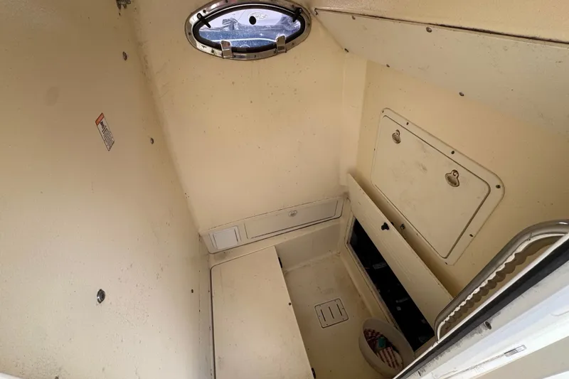 Slide: The Image of Interior cabin of a 2003 Scout 280 Sportfish boat, featuring storage compartments. - 13
