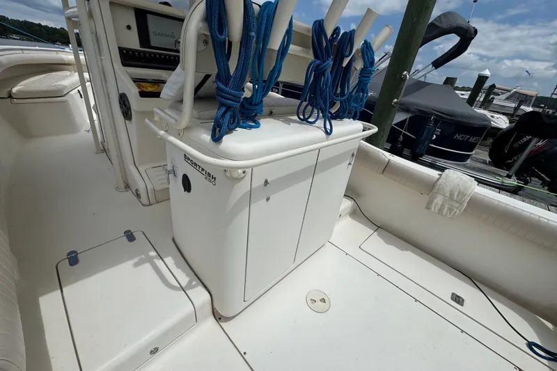 Slide: The Image of 2003 Scout 280 Sportfish boat interior with storage and blue ropes. - 6