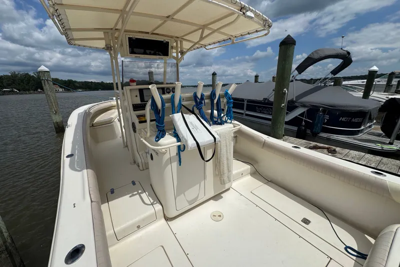 Slide: The Image of 2003 Scout 280 Sportfish boat docked at marina under cloudy sky. - 7