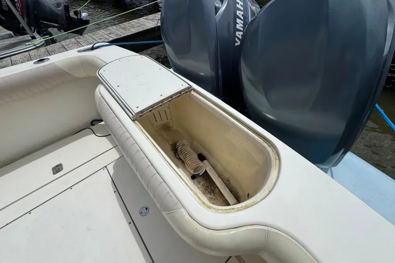 Slide: The Image of 2003 Scout 280 Sportfish boat interior with storage compartment and Yamaha engines. - 4