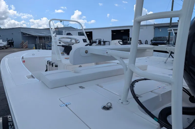 Slide: The Image of The image shows a modern boat with a white helm and seating. It is situated in a dock area. - 8