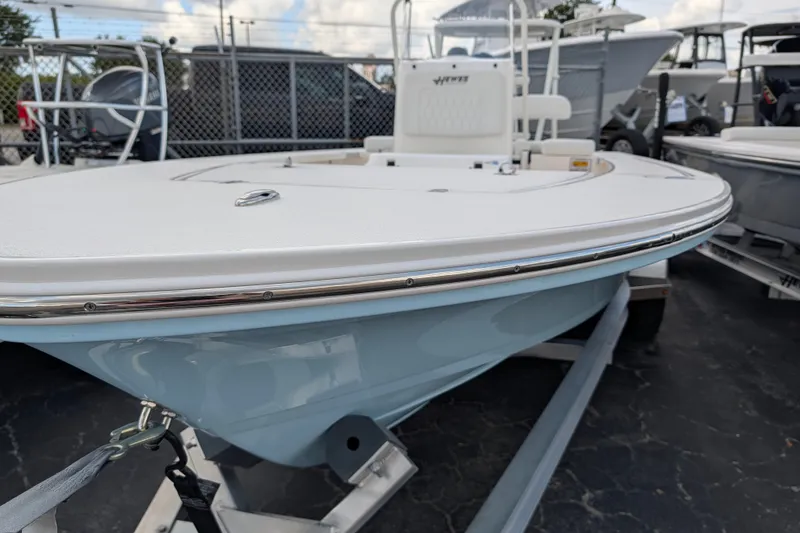 Slide: The Image of A 2027 Hewes Redfisher 16 sits on a trailer. It features a sleek, white deck. - 3