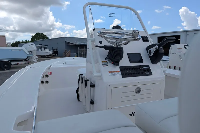 Slide: The Image of The image shows the cockpit of a 2027 Hewes Redfisher 16 with a steering console and controls. - 10