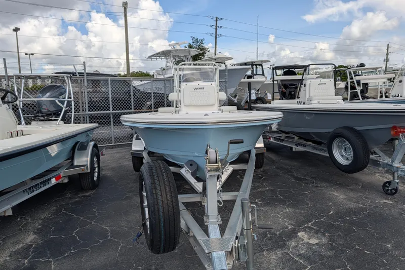 Slide: The Image of A 2027 Hewes Redfisher 16 boat is on a trailer in an outdoor lot. - 2