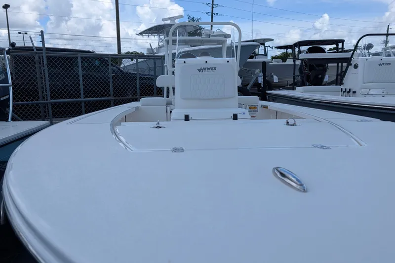 Slide: The Image of The image shows a 2027 Hewes Redfisher 16 boat parked in a lot. - 14