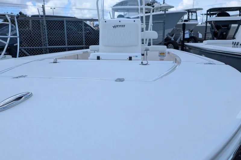 Slide: The Image of The image shows a 2027 Hewes Redfisher 16 boat with a clean, white deck. - 15