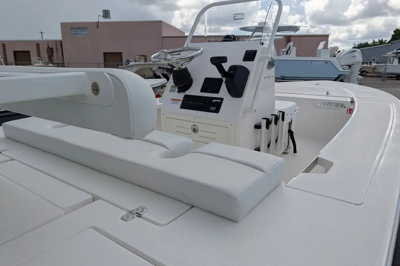 Slide: The Image of The image shows a 2027 Hewes Redfisher 16 boat with a white helm station. - 6