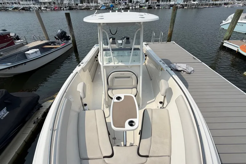 Slide: The Image of 2022 Sailfish 242 CC boat docked, featuring spacious seating and modern design. - 7