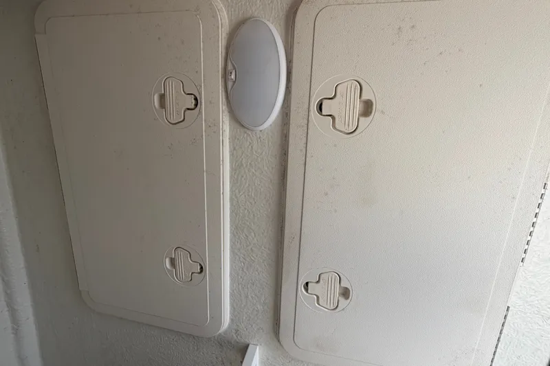 Slide: The Image of Storage compartments on a 2022 Sailfish 242 CC boat interior. - 23