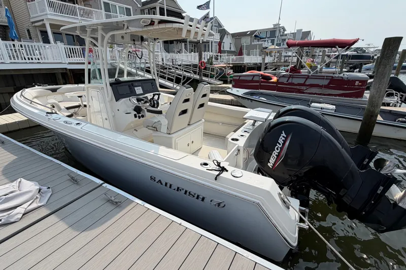 Slide: The Image of 2022 Sailfish 242 CC boat docked, featuring dual Mercury engines and modern design. - 5