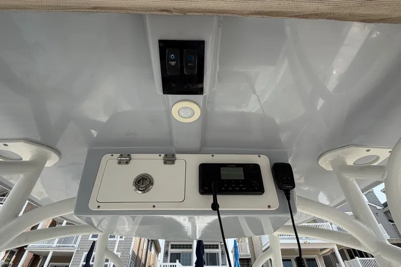 Slide: The Image of 2022 Sailfish 242 CC boat console with controls and communication equipment. - 17