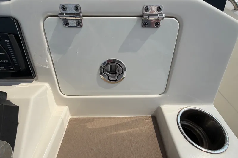 Slide: The Image of 2022 Sailfish 242 CC boat console with storage compartment and cup holder. - 14