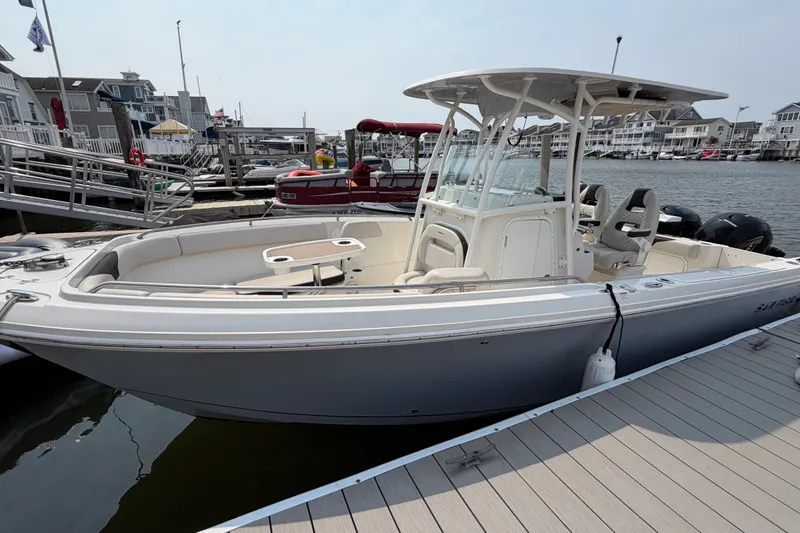 The Image of 2022 Sailfish 242 CC boat docked at marina, featuring sleek design and spacious seating. - 0