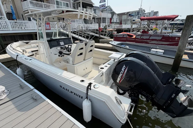 Slide: The Image of 2022 Sailfish 242 CC boat docked, featuring dual Mercury engines and sleek design. - 6
