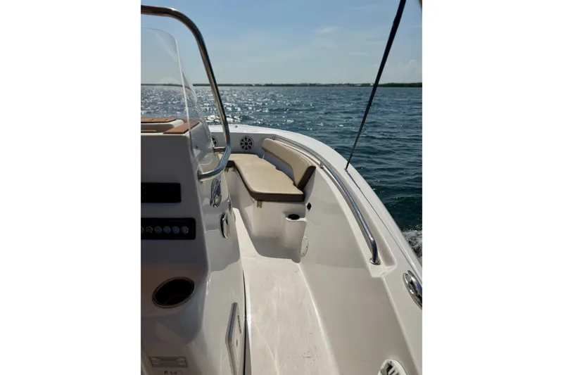 Slide: The Image of 2022 Tidewater 1910 Bay Max boat cruising on open water under clear skies. - 23