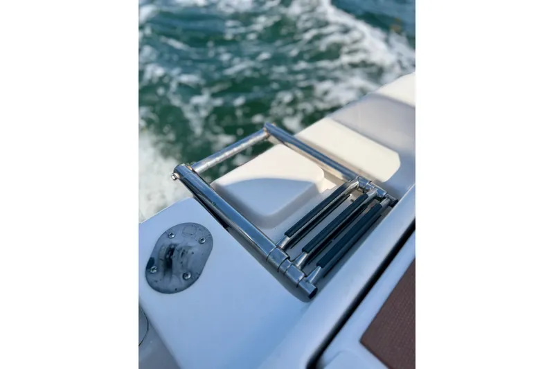 Slide: The Image of Stainless steel ladder on 2022 Tidewater 1910 Bay Max boat, with ocean waves in background. - 21