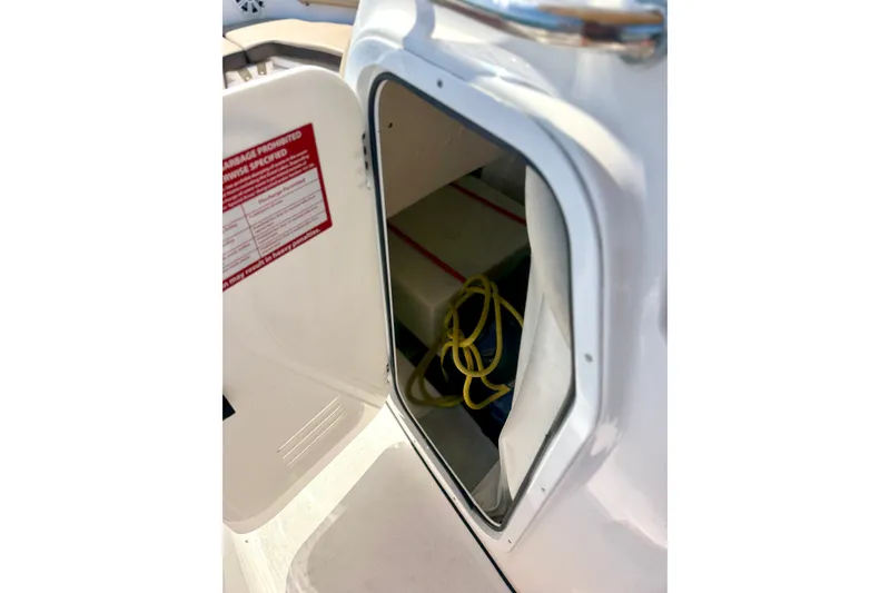 Slide: The Image of Open storage compartment on 2022 Tidewater 1910 Bay Max boat, showing interior contents. - 26