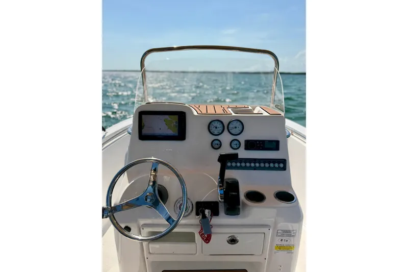 Slide: The Image of 2022 Tidewater 1910 Bay Max boat dashboard with steering wheel and navigation controls. - 15
