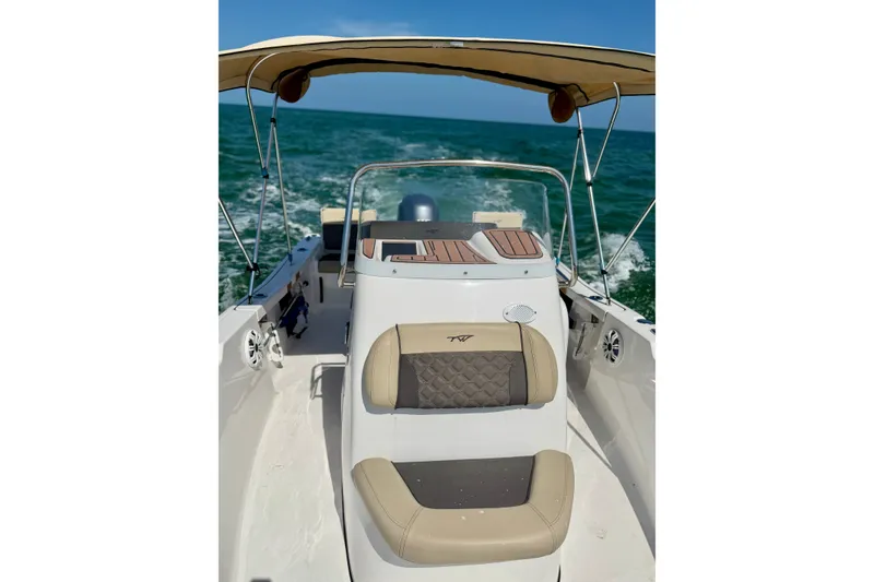 Slide: The Image of 2022 Tidewater 1910 Bay Max boat cruising on open water with canopy. - 18