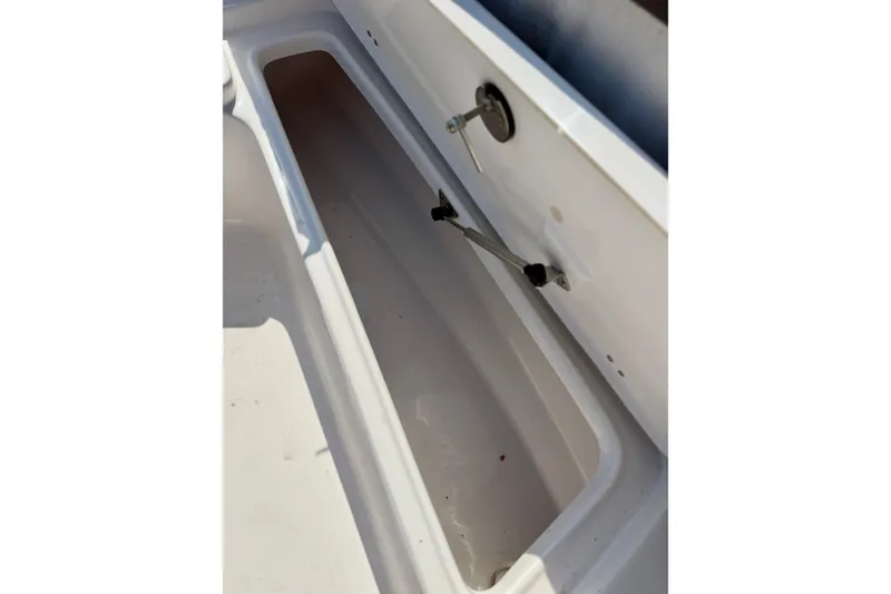 Slide: The Image of Storage compartment of a 2022 Tidewater 1910 Bay Max boat, featuring a clean interior. - 19