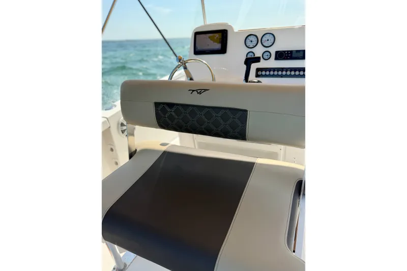 Slide: The Image of 2022 Tidewater 1910 Bay Max boat interior with modern dashboard and seating. - 17