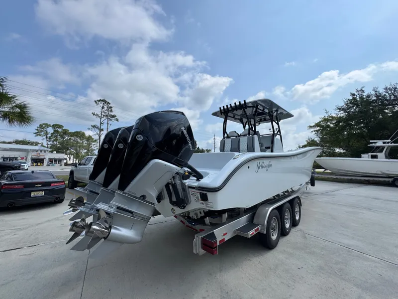 Slide: The Image of 2027 Yellowfin 34 Offshore boat on trailer, featuring triple outboard engines. - 14