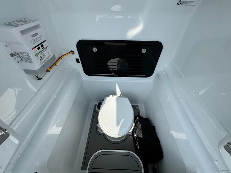 Slide: The Image of Interior of 2027 Yellowfin 34 Offshore boat featuring a compact marine toilet. - 28