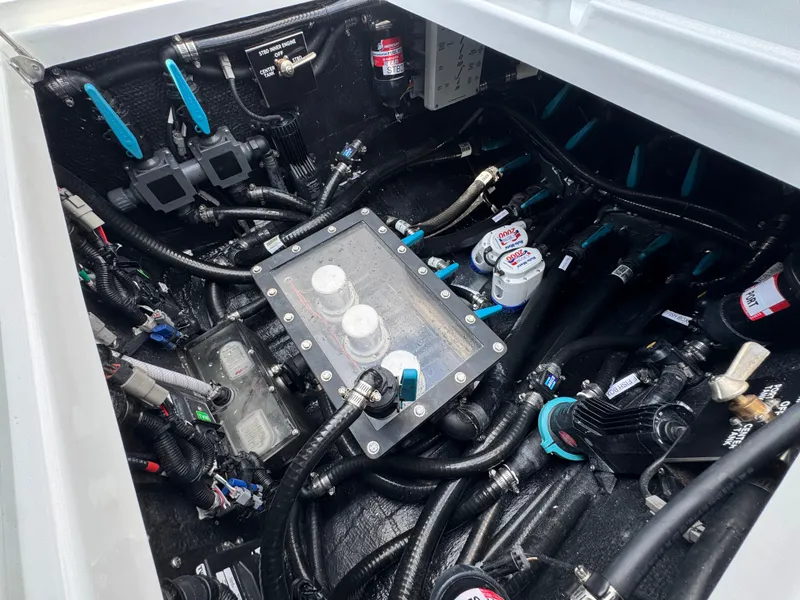 Slide: The Image of Engine compartment of a 2027 Yellowfin 34 Offshore boat, showcasing intricate wiring and components. - 47
