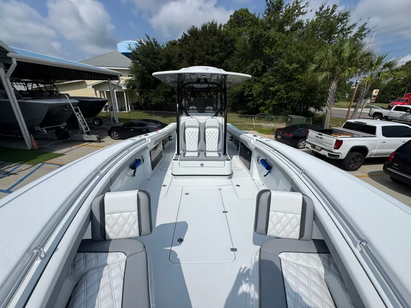 Slide: The Image of 2027 Yellowfin 34 Offshore boat with spacious deck and luxurious seating in a marina setting. - 26