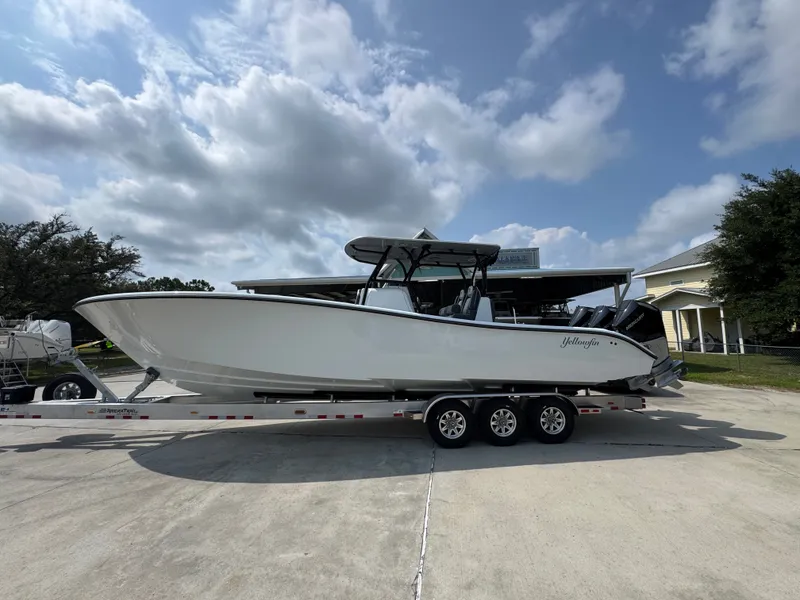 The Image of 2027 Yellowfin 34 Offshore boat on trailer under cloudy sky. - 1
