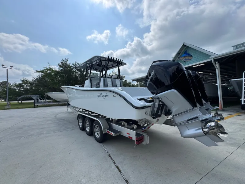 Slide: The Image of 2027 Yellowfin 34 Offshore boat on trailer, parked outdoors under a cloudy sky. - 18