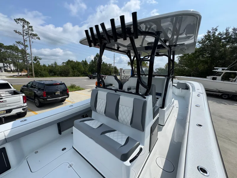 Slide: The Image of 2027 Yellowfin 34 Offshore boat with sleek seating and modern design in a parking lot. - 42