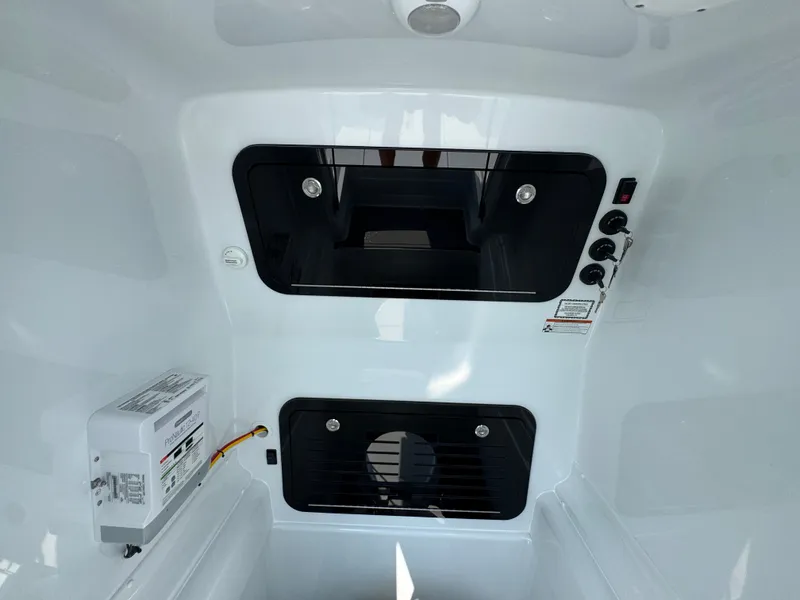 Slide: The Image of Interior view of 2027 Yellowfin 34 Offshore boat, featuring control panel and storage compartments. - 29
