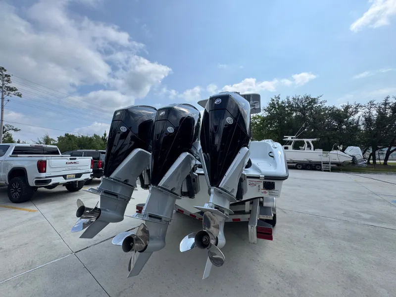Slide: The Image of 2027 Yellowfin 34 Offshore boat with triple outboard engines on a trailer. - 15