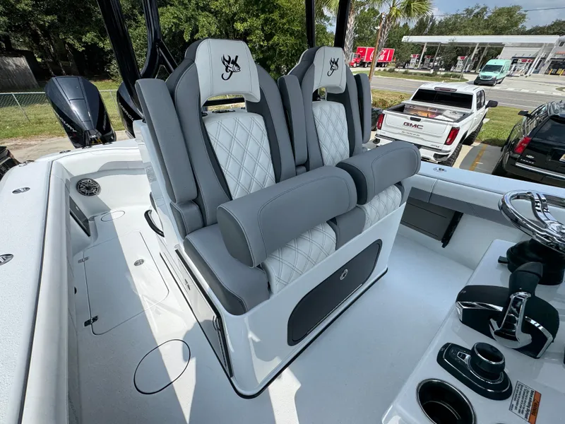 Slide: The Image of 2027 Yellowfin 34 Offshore boat interior with luxurious seating and modern controls. - 35