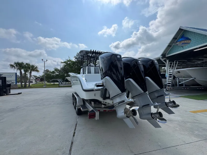 Slide: The Image of 2027 Yellowfin 34 Offshore boat with triple outboard engines on a trailer. - 17