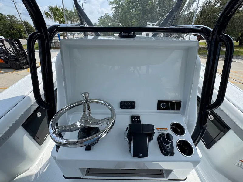 Slide: The Image of Control console of 2027 Yellowfin 34 Offshore boat with steering wheel and navigation controls. - 37