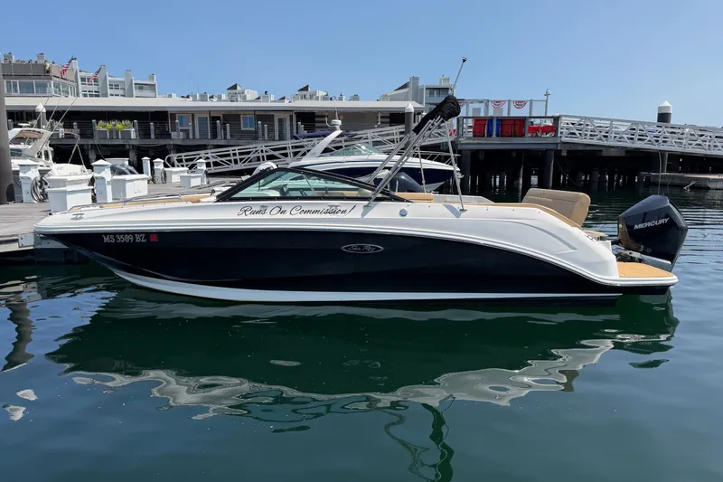 The Image of 2019 Sea Ray SDX 250 Outboard boat docked at marina, featuring sleek design and Mercury engine. - 0