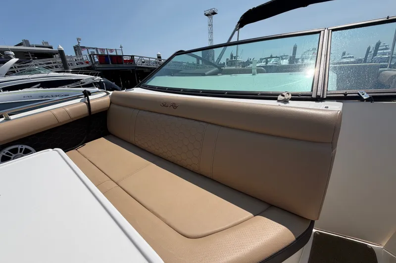Slide: The Image of 2019 Sea Ray SDX 250 Outboard boat interior with tan seating and waterfront view. - 17